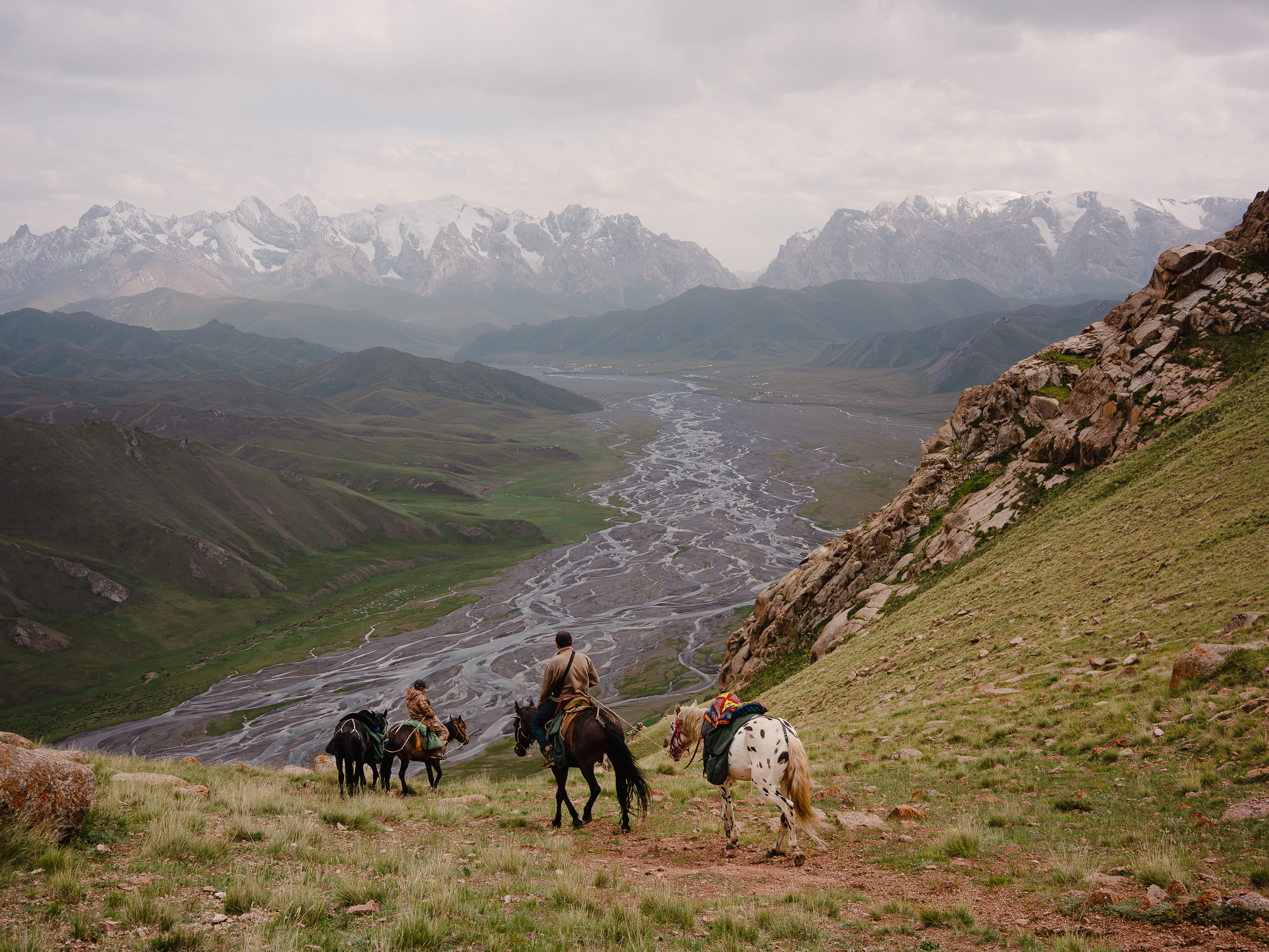 Riders descending mountain pass in Kyrgyzstan